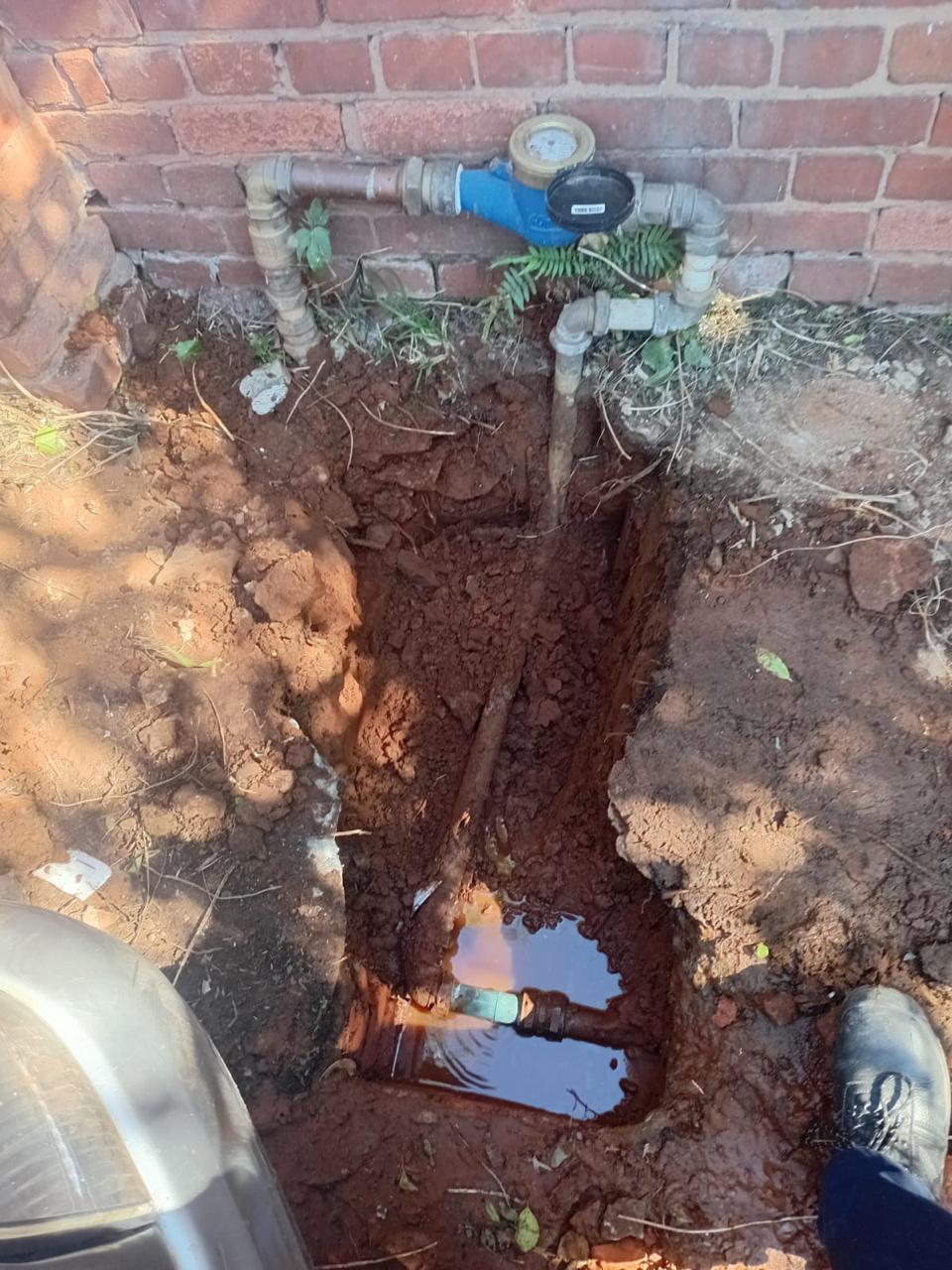 Water meter and pipework installed in an excavated trench